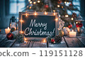 Festive chalkboard and Christmas decorations, lighting garland, pine cone near Christmas tree. Text - Merry Christmas! Xmas card. 119151128