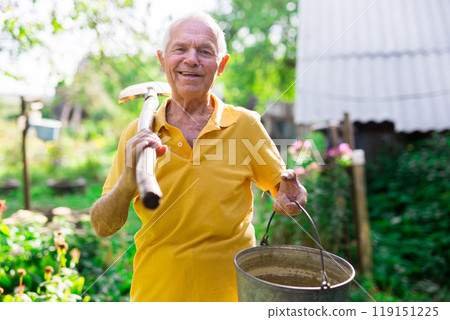Portrait of mature farmer with shovel on garden 119151225