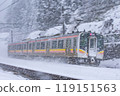 A train on the Shinetsu Main Line passing through snowy scenery 119151563