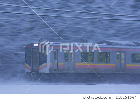 A train on the Shinetsu Main Line running through the snowy scenery A train on the Shinetsu Main Line running through the snowy scenery 119151564
