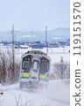 A train in Hokkaido travelling through snowy scenery 119151570