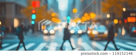 A blurry photo of a busy city street with people walking and cars driving 119152146