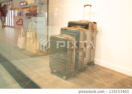 Travelers choose baggage in the store.  119153403