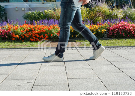 The feet of people walking down the street 119153723