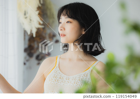 Woman opening curtain 119154049