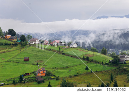 Misty morning in Vorokhta village with scenic view of Carpathian hills and fog-covered mountains Misty morning in Vorokhta village with scenic view of Carpathian hills and fog-covered mountains 119154062