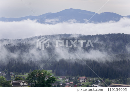 Foggy morning in Vorokhta with view of Carpathian forest and mountains. Scenic nature landscape Foggy morning in Vorokhta with view of Carpathian forest and mountains. Scenic nature landscape 119154095