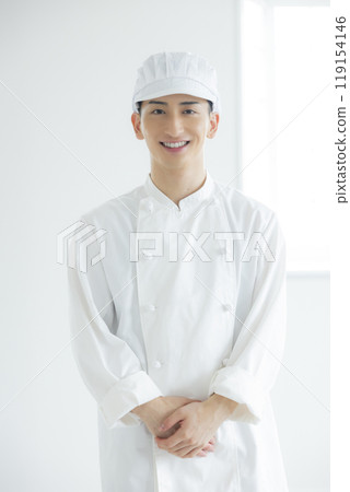 A young man wearing a chef's coat A young man wearing a chef's coat 119154146