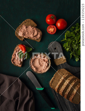 Liver meat pate spread on rye bread, breakfast, close-up, dark background. no people, selective focus, 119154223