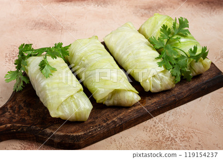 raw cabbage rolls, not cooked, with minced meat, top view, without people, in the spotlight. raw cabbage rolls, not cooked, with minced meat, top view, without people, in the spotlight. 119154237