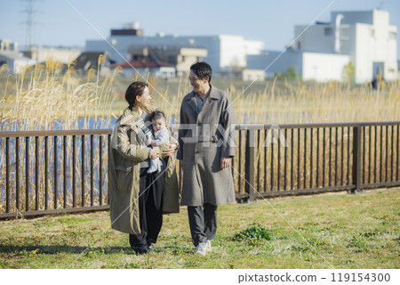 Family taking a walk in winter 119154300
