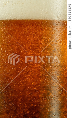 Close-up of beer pouring into pint , freeze motion. 119154325