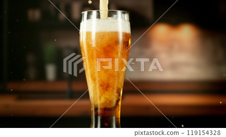 Close-up of beer pouring into pint , freeze motion. 119154328