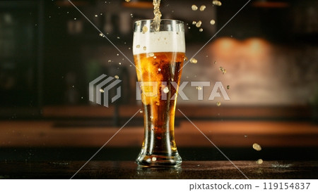 Pouring Beer Drink into a Long Glass. 119154837