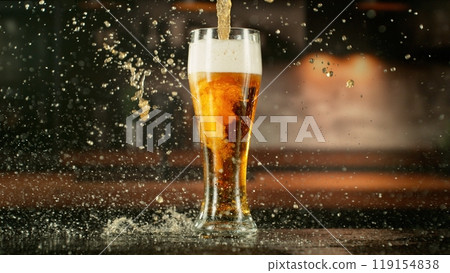 Pouring Beer Drink into a Long Glass. 119154838