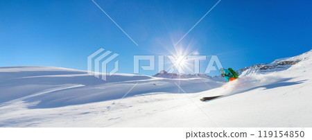 Man skier running downhill on sunny alpine slope 119154850