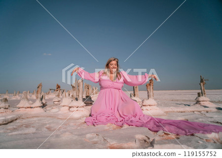 Woman Pink Dress Salt Formations Lake - A woman in a pink dress poses in front of salt formations in a lake. Woman Pink Dress Salt Formations Lake - A woman in a pink dress poses in front of salt formations in a lake. 119155752