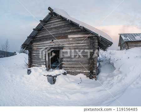 Abandoned house on the edge of the village in winter. Abandoned house on the edge of the village in winter. 119156485