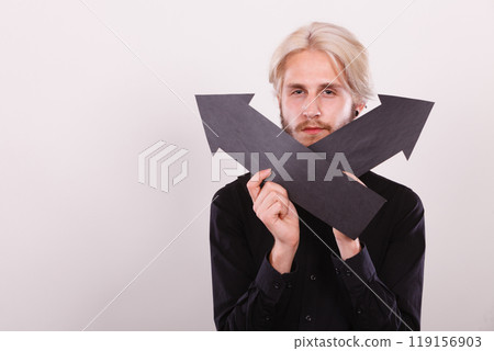 Man holding black arrows pointing left and right Man holding black arrows pointing left and right 119156903