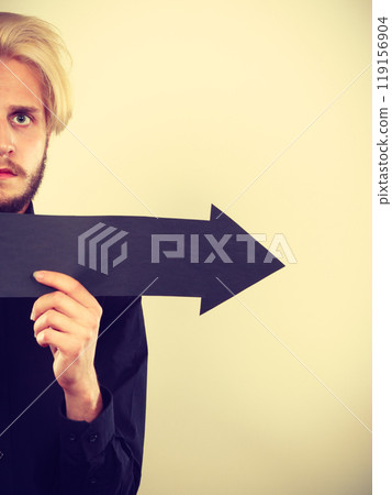 Man holding black arrow pointing right Man holding black arrow pointing right 119156904