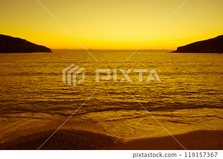 Sunset or sunrise over sea surface 119157367