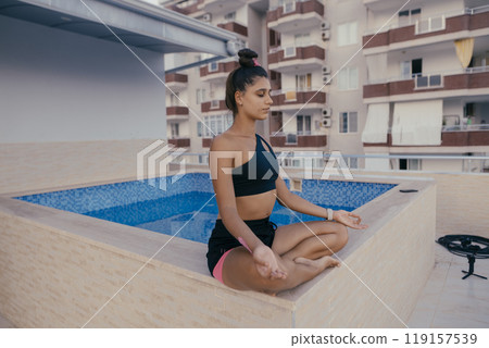 Experience blissful serenity in meditation by the relaxing poolside environment 119157539