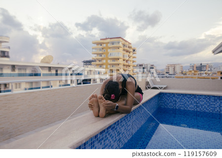 Experience a relaxing moment at the rooftop pool while taking in the amazing scenic view Experience a relaxing moment at the rooftop pool while taking in the amazing scenic view 119157609