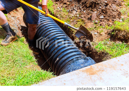 Construction of trench for drainage black pipe at construction site Construction of trench for drainage black pipe at construction site 119157643