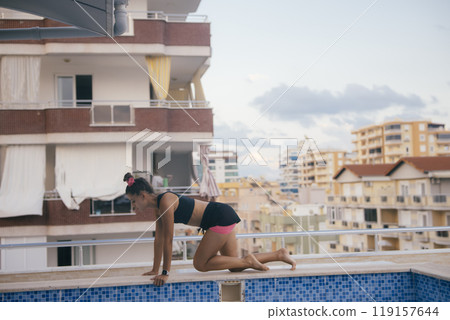 Experience a vibrant Urban Fitness Routine while soaking up the sun by the Poolside Experience a vibrant Urban Fitness Routine while soaking up the sun by the Poolside 119157644