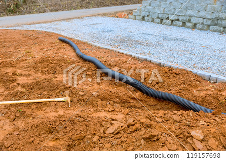 Trench is dug to lay drainage pipes for storm water that are located underground 119157698
