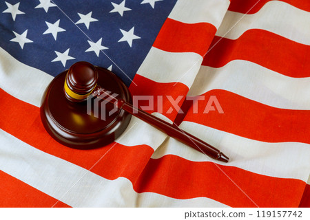Judge gavel adorned with American flag represents legal system in United States 119157742