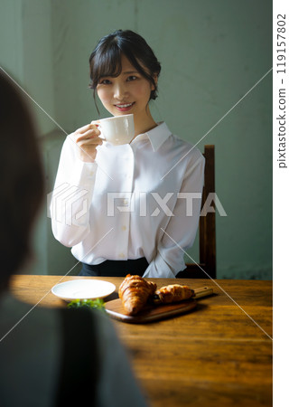 Young woman drinking a cup of coffee in a calm atmosphere in the morning Young woman drinking a cup of coffee in a calm atmosphere in the morning 119157802