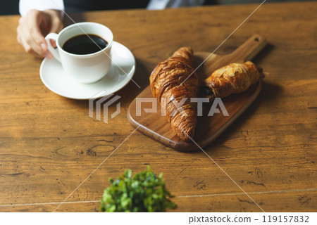 Young woman drinking a cup of coffee in a calm atmosphere in the morning Young woman drinking a cup of coffee in a calm atmosphere in the morning 119157832