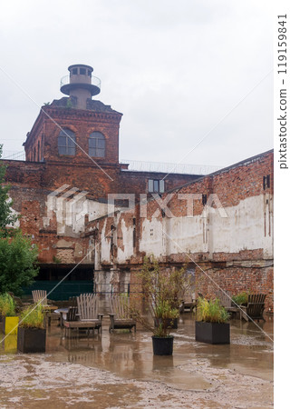 public space on the territory of the former factory in rainy weather 119159841