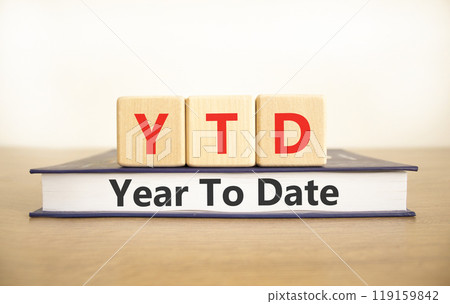 YTD year to date symbol. Concept words YTD year to date on beautiful wooden blocks and book. Beautiful white background. Business YTD year to date concept. Copy space. YTD year to date symbol. Concept words YTD year to date on beautiful wooden blocks and book. Beautiful white background. Business YTD year to date concept. Copy space. 119159842