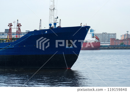 ships in a cargo port on a cloudy day 119159848