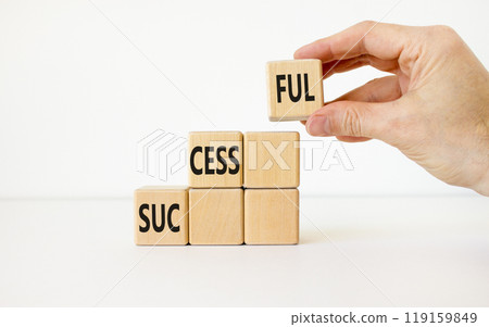 Successful symbol. Concept word Successful on beautiful wooden cubes. Businessman hand. Beautiful white background. Business successful concept. Copy space. Successful symbol. Concept word Successful on beautiful wooden cubes. Businessman hand. Beautiful white background. Business successful concept. Copy space. 119159849