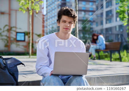 Young guy college student using laptop outdoor Young guy college student using laptop outdoor 119160267