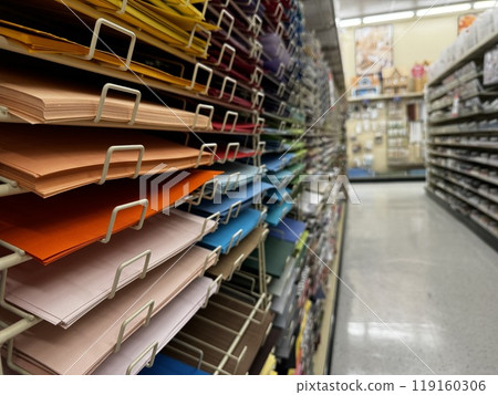 multi-colored paper sheets stacked on shelves in a craft store aisle multi-colored paper sheets stacked on shelves in a craft store aisle 119160306