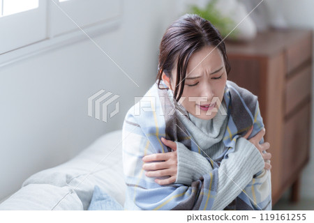 A woman with poor circulation wearing winter clothes A woman with poor circulation wearing winter clothes 119161255