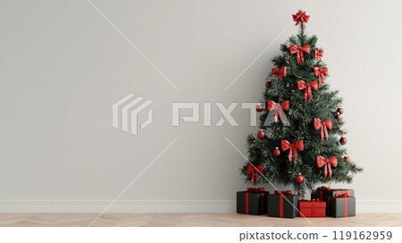 A Christmas tree with red bows on it is standing in front of a white wall 119162959