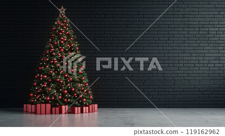 A large Christmas tree with red and green decorations sits in front of a brick wall. A large Christmas tree with red and green decorations sits in front of a brick wall. 119162962