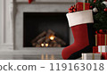 A red stocking sits in front of a fireplace with a tree and presents. 119163018