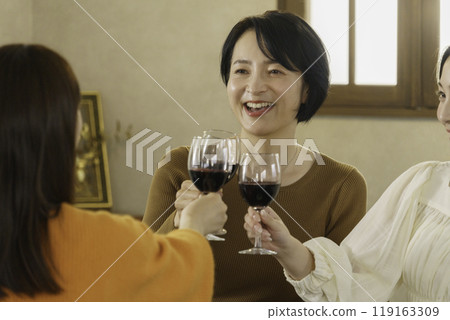 Girls' party: Three women toasting with wine Girls' party: Three women toasting with wine 119163309