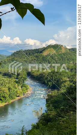 Mountain river and green forest. Blue sky with clouds. Mindanao, Philippines. 119163617