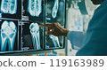 X-ray image of a human knee joint. Orthopedic surgeon doctor examining patient's knee joint x-ray films. Doctor examine patient's joint x-ray scan. 119163989