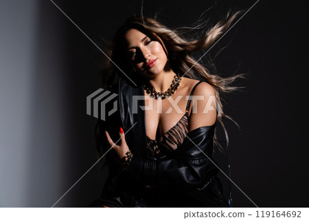 Erotic girl with long dark hair tenderly hugging herself. Concept: self-acceptance, love for your body Erotic girl with long dark hair tenderly hugging herself. Concept: self-acceptance, love for your body 119164692