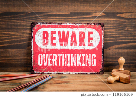 Overthinking. Beware sign with text on a wooden texture office table 119166109
