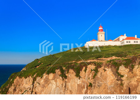 Lighthouse on the cliff at Cabo da Roca. Cabo da Roca or Cape Roca is westernmost cape of mainland Portugal, continental Europe and the Eurasian land mass 119166199