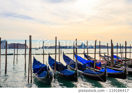 Traditional Gondolas moored on the pier in the Grand Canal in Venice, Italy Traditional Gondolas moored on the pier in the Grand Canal in Venice, Italy 119166417